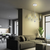 Modern living room with a chandelier, sofa, and kitchen in the background.