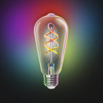 Decorative light bulb with colorful spiral filament on a gradient background