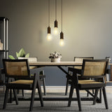 Dining room with a table and chairs under pendant lights.